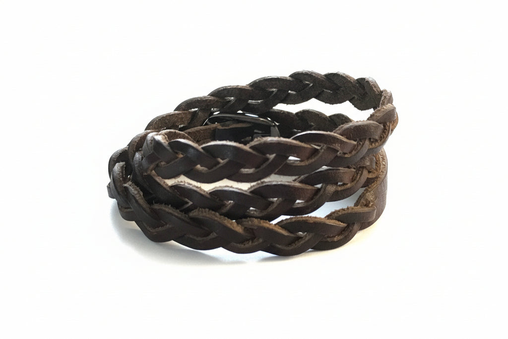 Black braided bracelet on a wooden surface