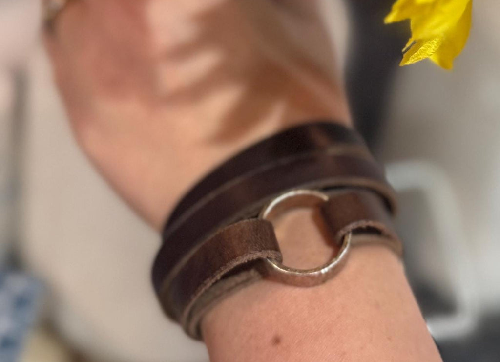 Hand holding sunflowers with a blurred background