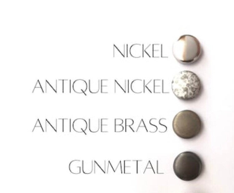 Metallic buttons in nickel, antique nickel, antique brass, and gunmetal on a white background.