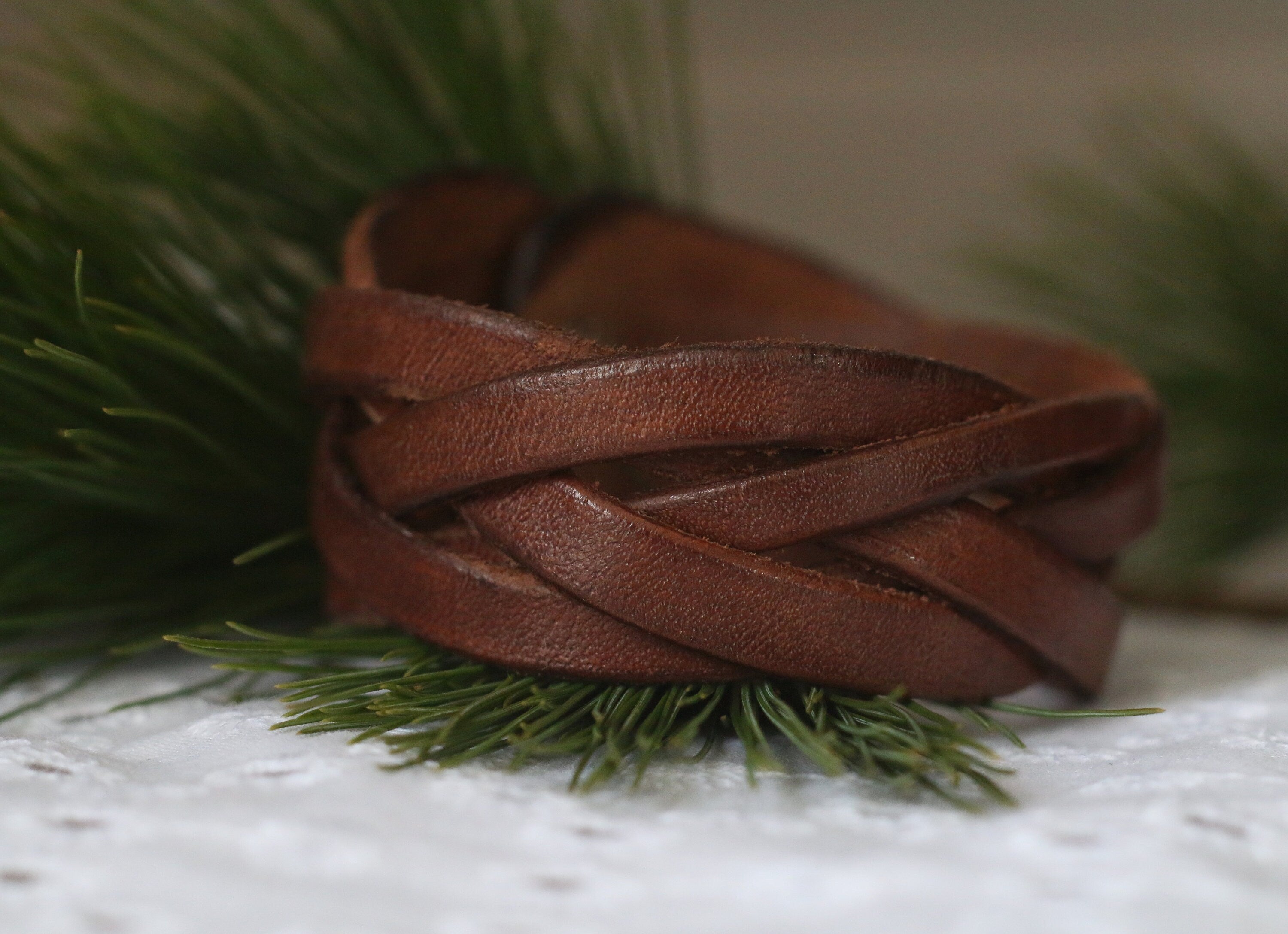 Brown leather bracelet on a grassy background