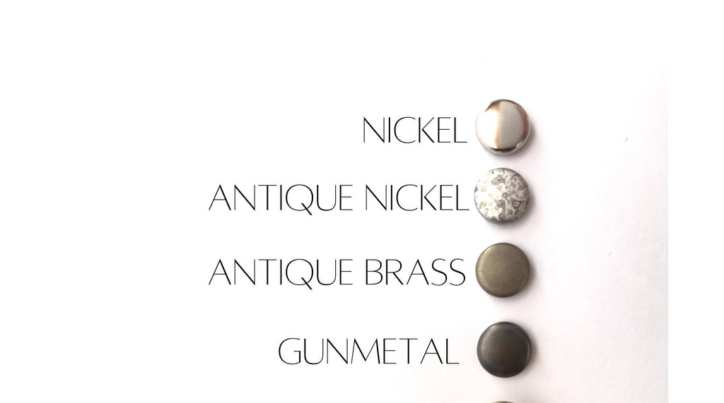 Set of metallic buttons labeled 'Nickel', 'Antique Nickel', 'Antique Brass', 'Gunmetal' on a white background.
