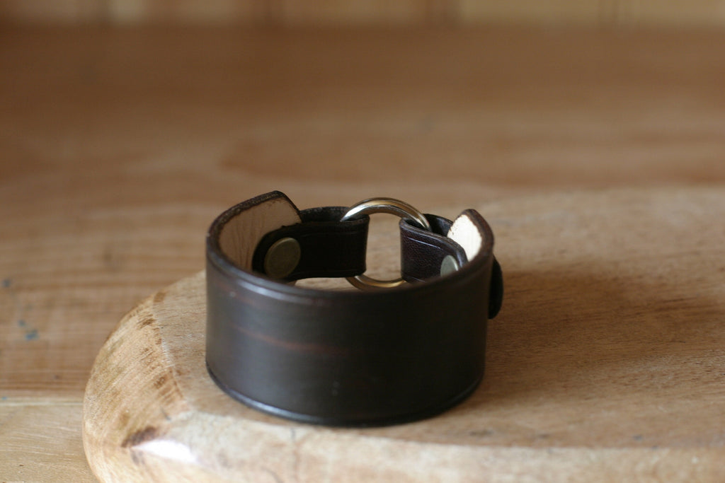 Black leather wear the ring
 on a wooden surface