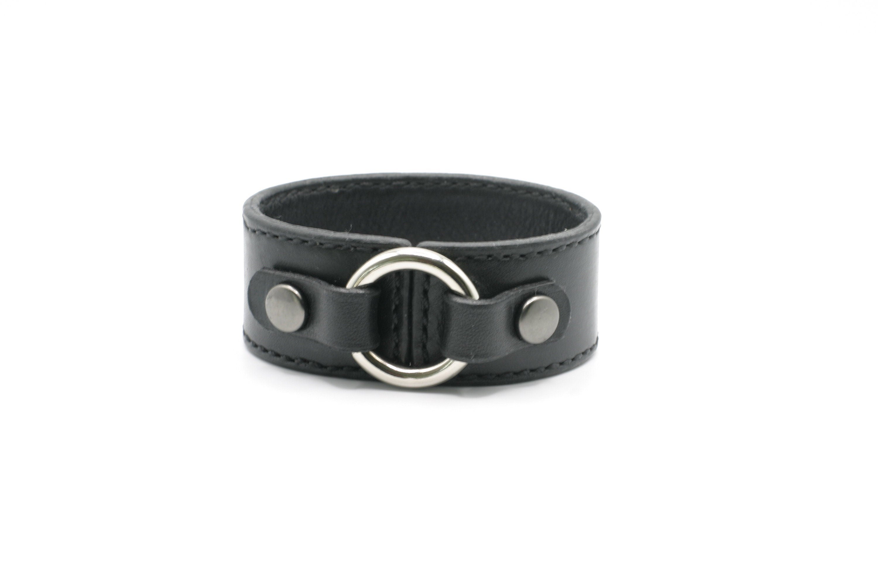 Black leather wear the ring bracelet with silver ring and studs on a white background