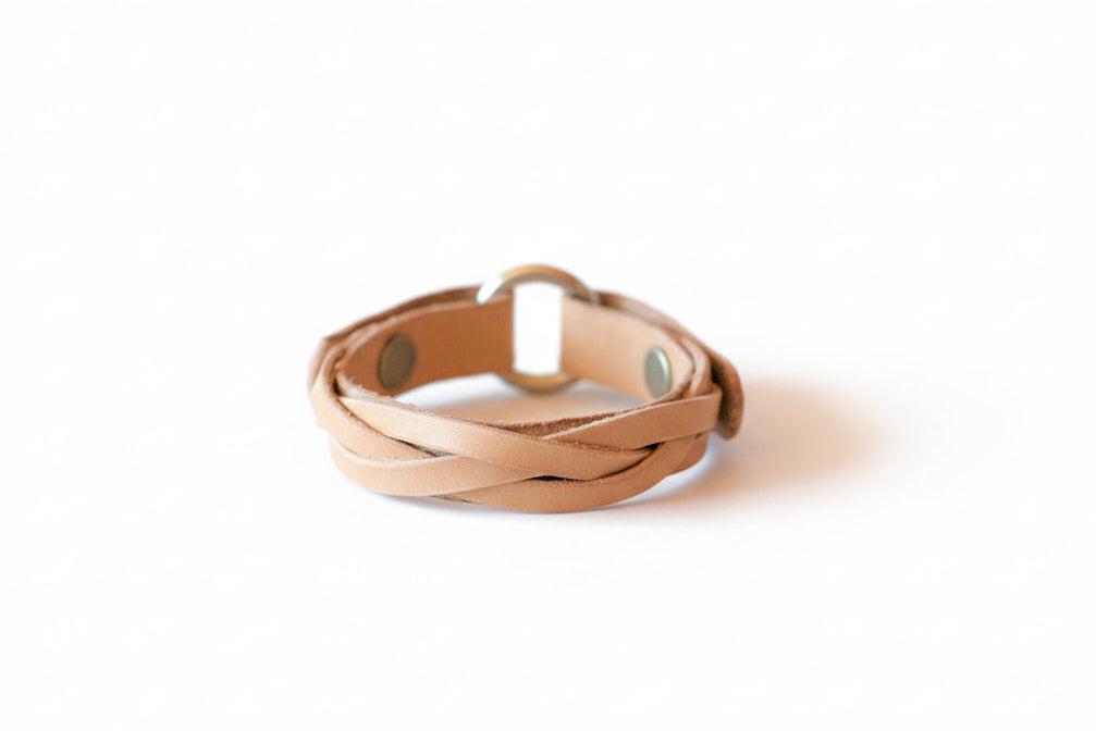 Beige wear the ring braided bracelet on a white background